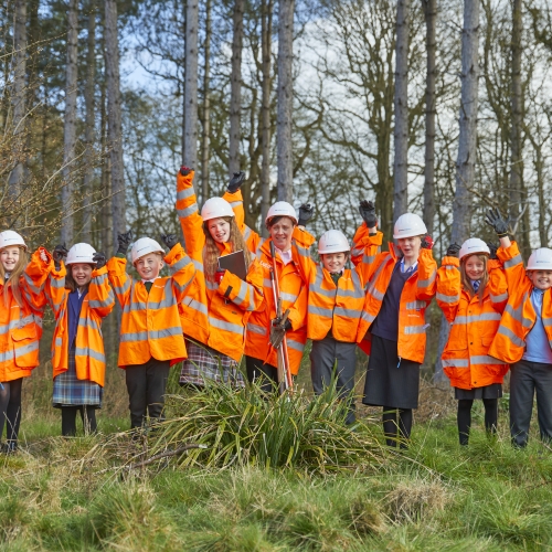 Teacher and pupils in woodland